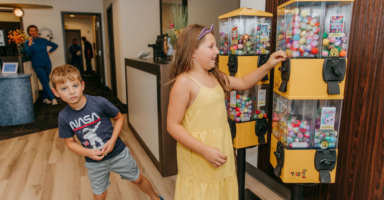 two kids getting prize at dental office