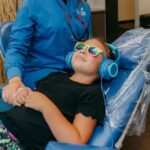 dental hygienist comforting a little girl at the dental office