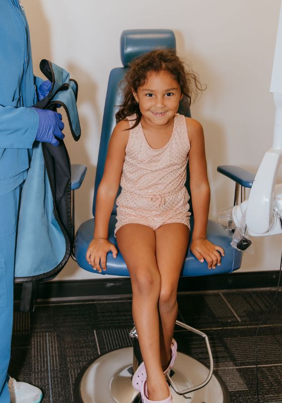 little girl sitting in dental chair