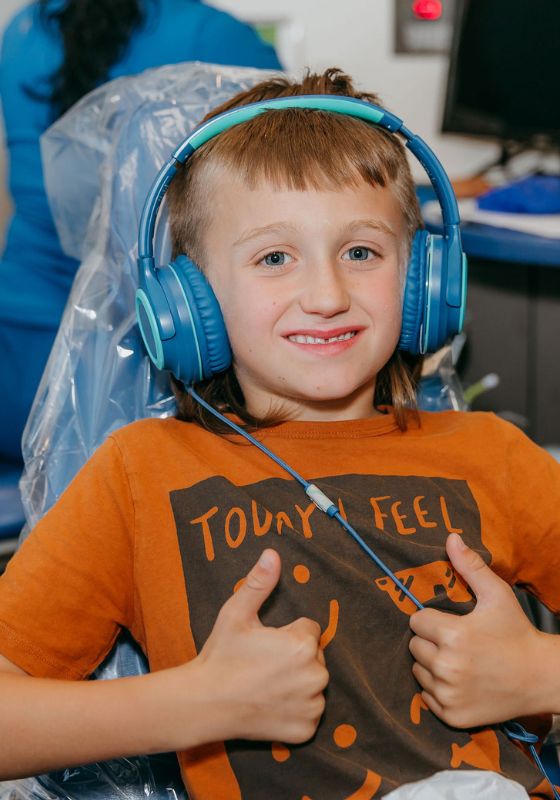 two thumbs up in the dentist chair