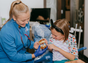 kid brushing teeth at dental office